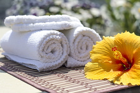 three white towels near yellow flower thumbnail