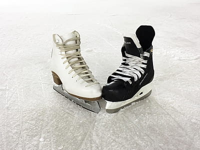 pair of black and white ice skate shoes on snow thumbnail