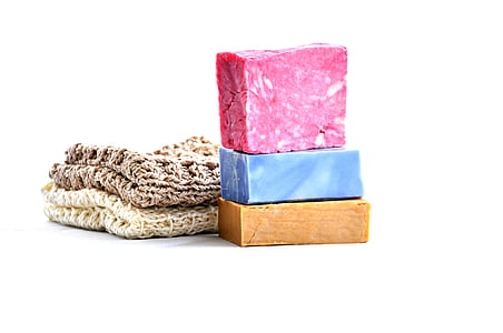 two knitted textiles beside wooden bars thumbnail