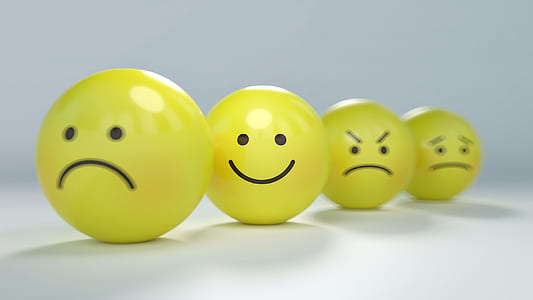 four assorted emoji balls focusing on smiley emoji thumbnail