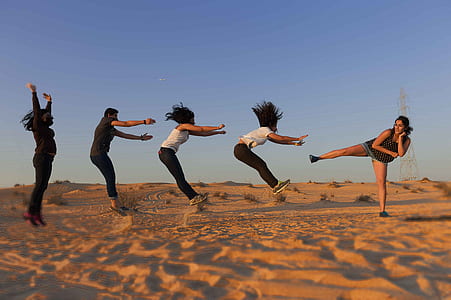 five person doing aerobic moves during daytime thumbnail