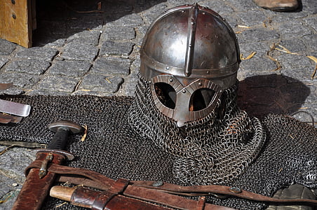 gray chain mail helmet and armor on gray brick floor thumbnail