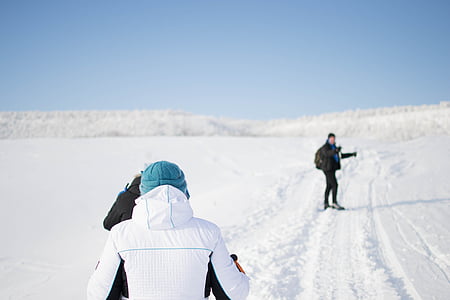 person standing on snow field during daytime thumbnail