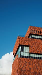 photo of brown concrete building under clear blue sky during daytime thumbnail