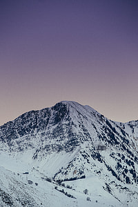 snow-coated mountain under clear blue sky thumbnail