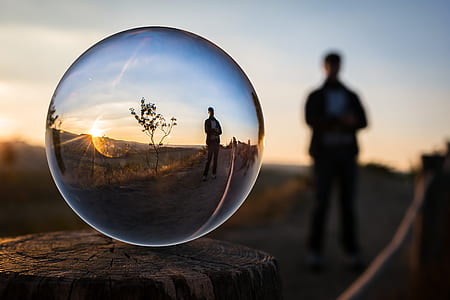 water drop photography of man standing near tree thumbnail