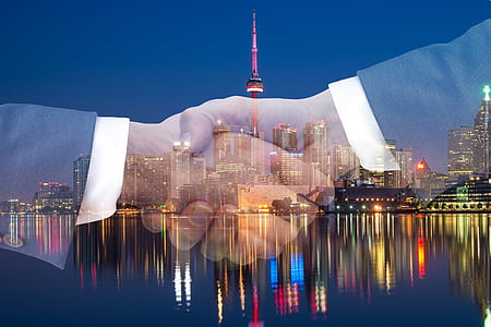 double posture photography of shaking hands and cityscape thumbnail