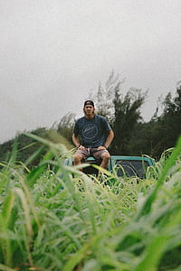 man sitting on vehicle roof thumbnail