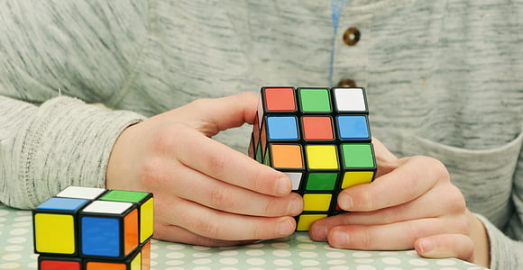 person holding 3 by 3 Rubik's cube thumbnail