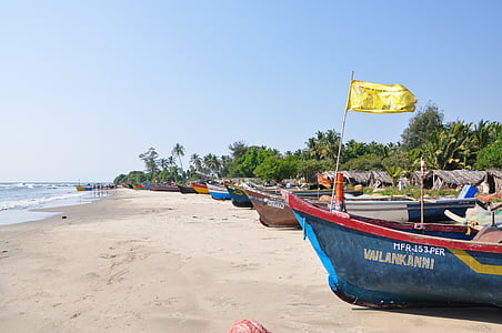 close-up photo of blue and red canoe beside beach during daytime thumbnail
