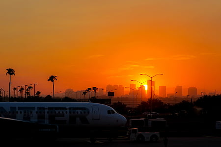white and red plane on gray pavement thumbnail