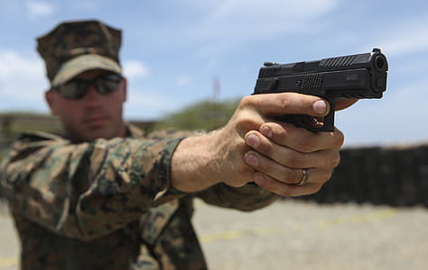 person holding pistol thumbnail