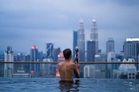 topless man in pool using action camera thumbnail