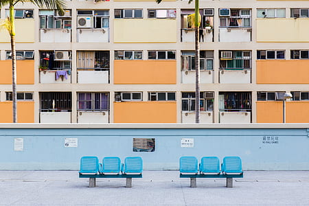two blue gangchairs in front of building thumbnail