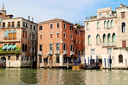 brown wall paint building near on body of water thumbnail