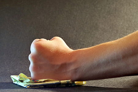 person's fist on yellow paper thumbnail