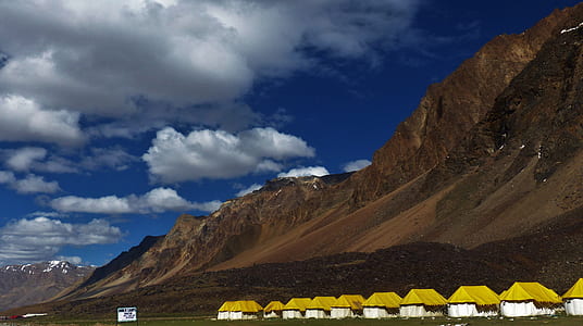 houses near body of mountain thumbnail
