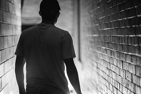 man standing near wall thumbnail