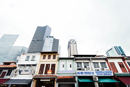 low angle of houses beside building thumbnail