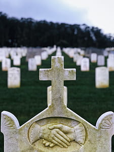 selective focus photography of white cross tombstone thumbnail