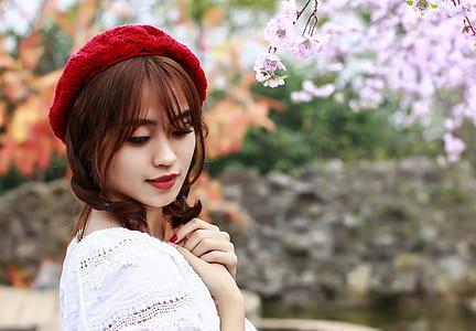 woman wearing red knit cap and white top thumbnail