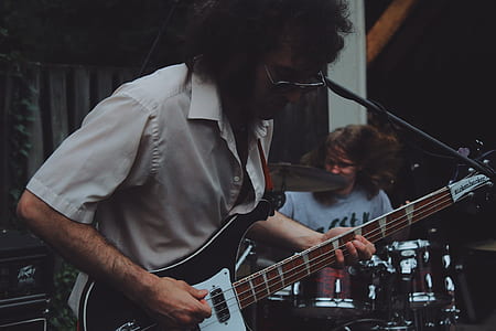 man playing bass electric guitar on stage thumbnail