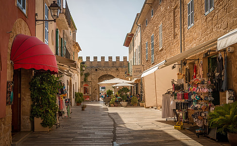 empty street between brown stone buildings during day thumbnail