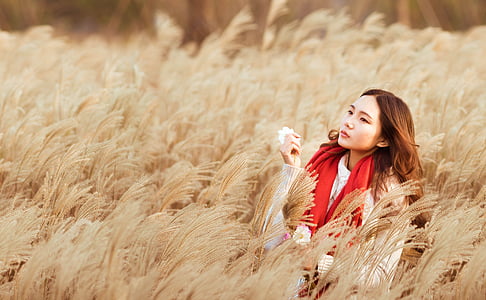 woman in field during daytime thumbnail