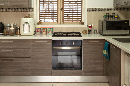 brown wooden kitchen cabinet with built in gas range oven thumbnail