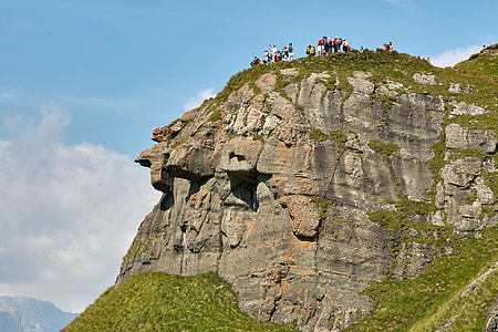group of people standing on cliff thumbnail