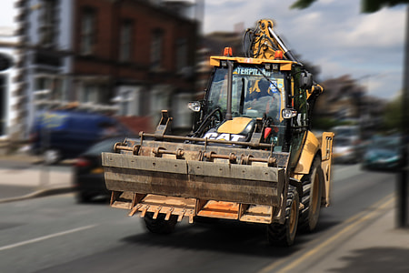 tilt shift photography tractor with plow thumbnail