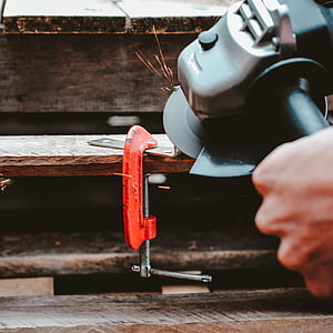 person holding black and silver angle grinder thumbnail