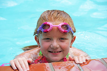 brown haired girl on body of water wearing pink goggles thumbnail