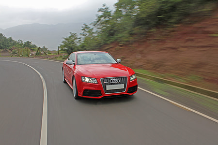 red Audi car near green leafed tree during daytime thumbnail