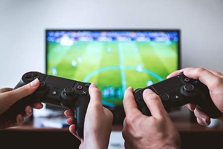 Two friends gaming on PlayStation and television thumbnail