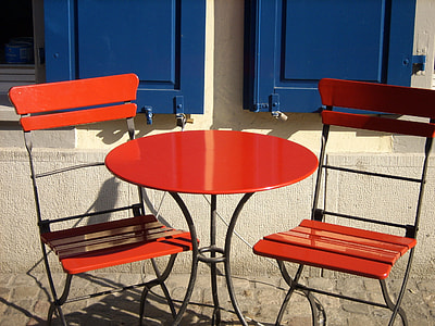 photo of red patio bistro table with chairs near the blue casement window thumbnail
