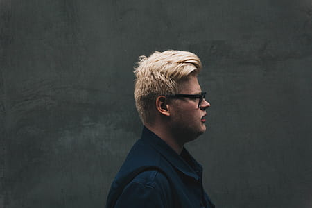 person near black painted wall posing for photo thumbnail