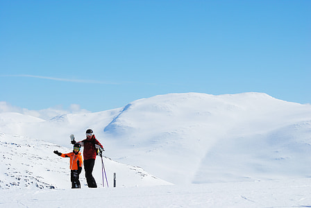 man and woman walking on snow thumbnail