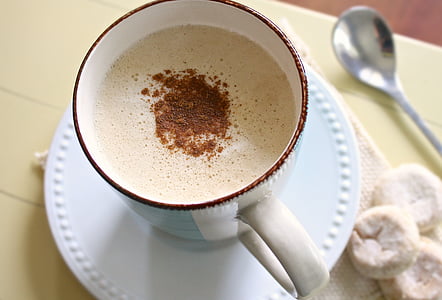 drink on cup beside spoon on table thumbnail