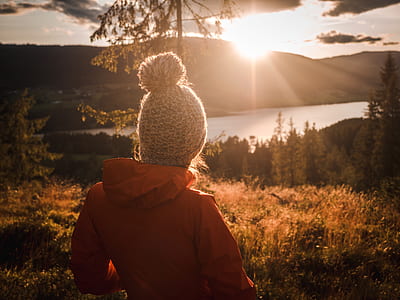 person wearing gray beanie looking at sun thumbnail
