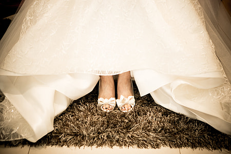 woman wearing white gown showing her shoes thumbnail