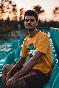 Photo of Man Sitting on Blue Chair thumbnail
