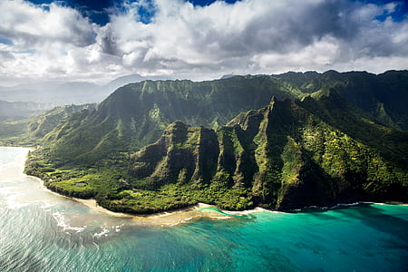 green island near blue sea under white and blue sky during daytime photography thumbnail