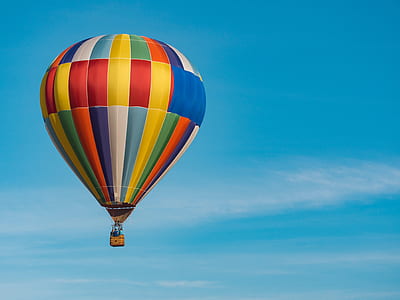 multicolored hot air balloon under cloudy sky during daytime thumbnail