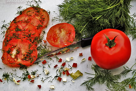 knife beside sliced tomatoes thumbnail