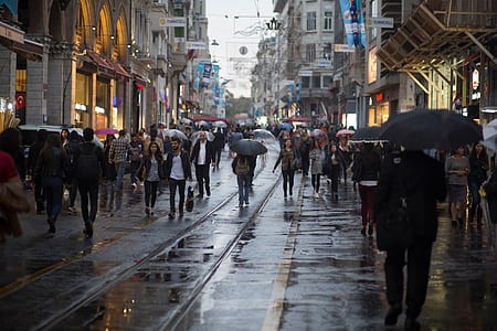 group of people walking on road between buildings thumbnail