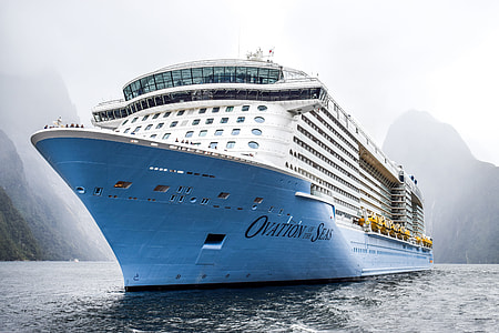 photography of cruiser ship near mountains thumbnail