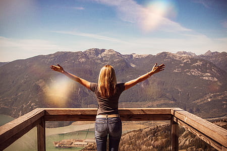 Woman Facing Mountains Raising Her Hands thumbnail