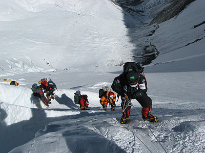 group of people hiking on snow mountain cliff thumbnail