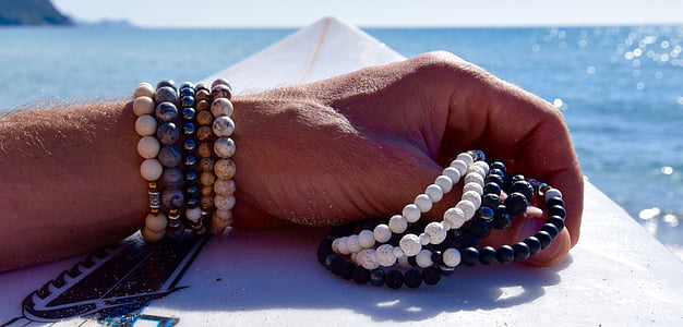 human holding beaded accessories thumbnail